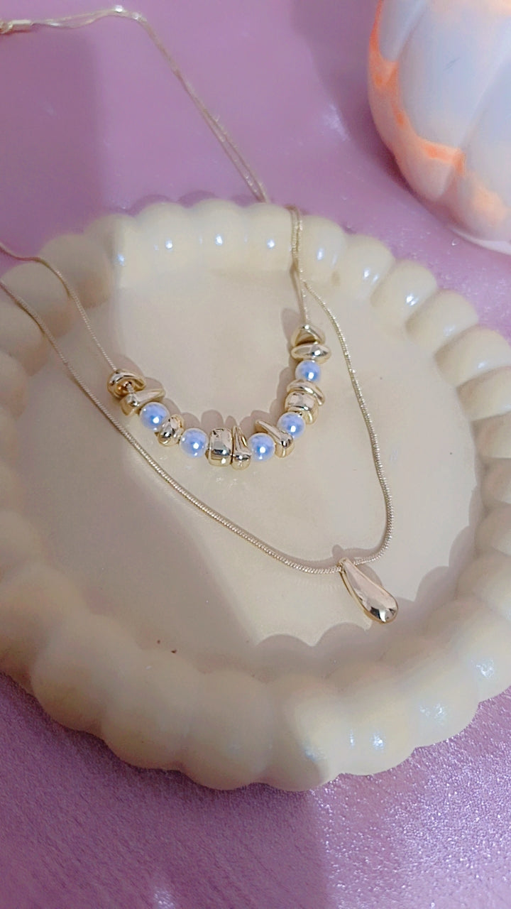 Double Layered Gold Necklace with Pearl and Teardrop Pendant.
