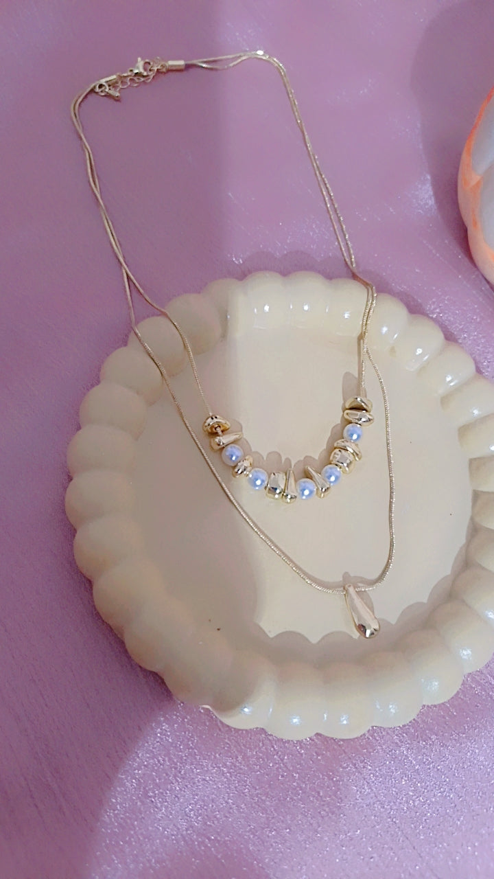 Double Layered Gold Necklace with Pearl and Teardrop Pendant.